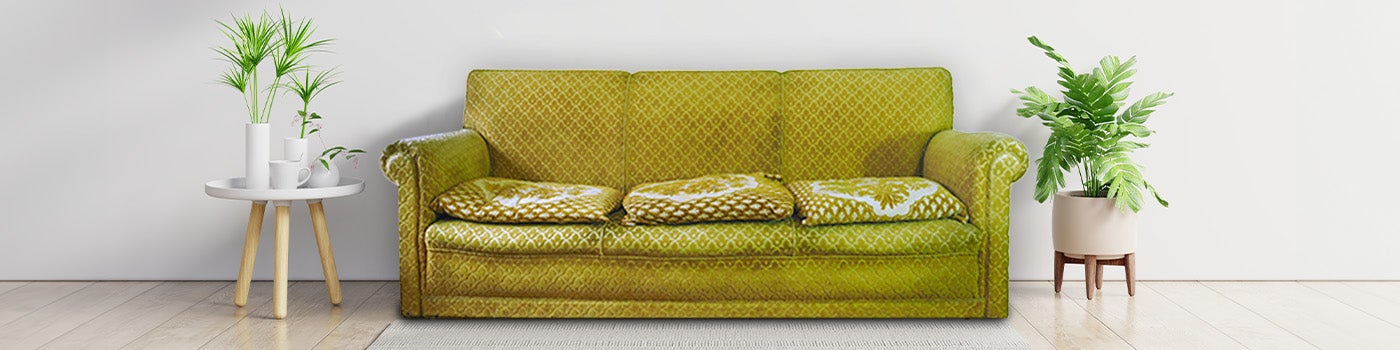 Old green couch that's ready for furniture removal and disposal