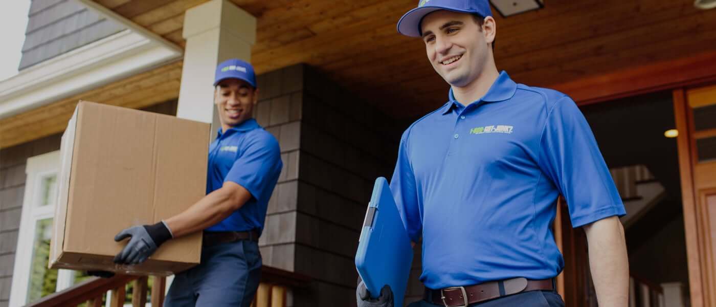 Happy 1800-GOT-JUNK? junk removal experts finishing a junk removal job